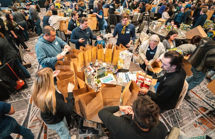Sound staff gathered around a table to prepare meal kits.