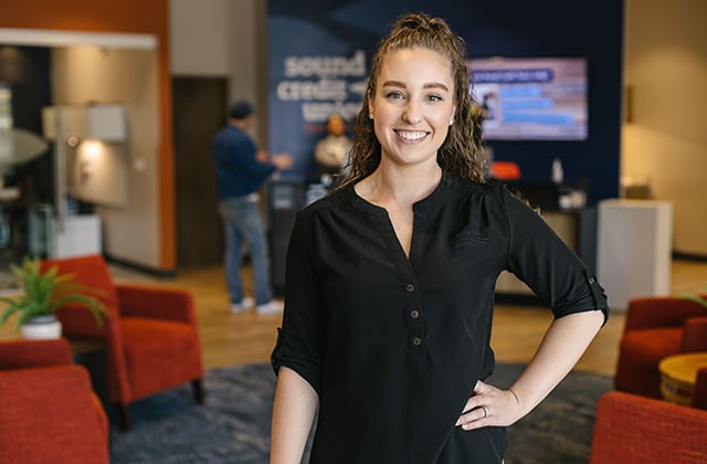 sound associate smiling in sound credit union lobby