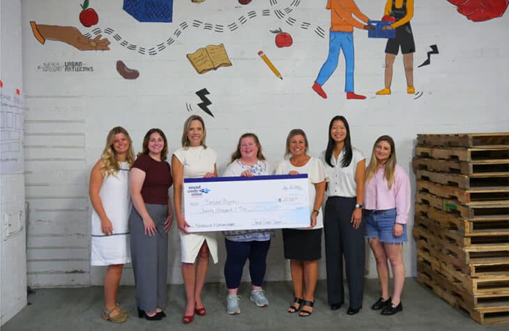 Sound Credit Union team members present Backpack Brigade with a $20,000 donation raised through the credit union's annual employee fundraiser.