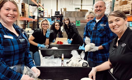 volunteers from Sound helping pack food at a local food bank