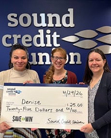 Photo of Denise accepting her Save to Win prize.