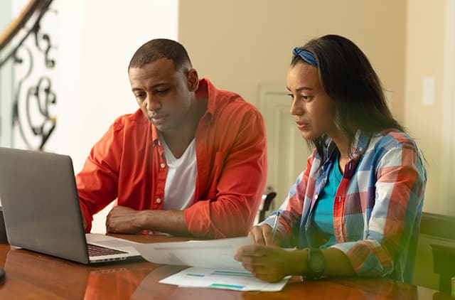 Two people looking over documents.