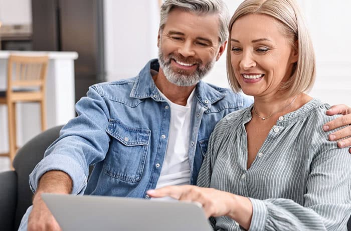 Man and woman using a laptop.