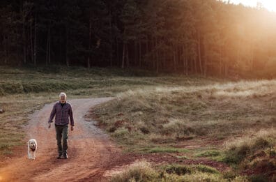 Man walking dog along trail