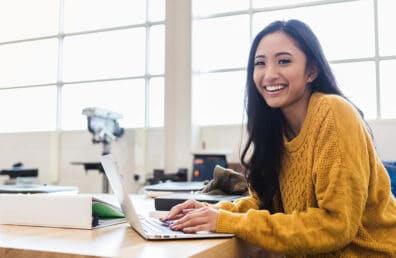 A female student smiling while facing the camera.