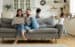 While active kids running parents resting on sofa using laptop