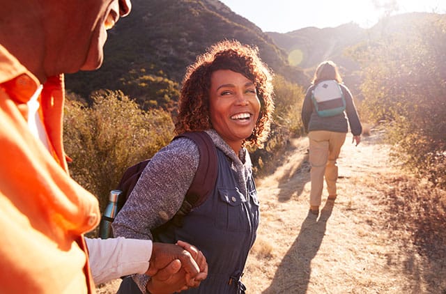Woman Helping Man On Trail