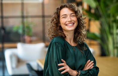 A confident woman smiling kindly at the camera.