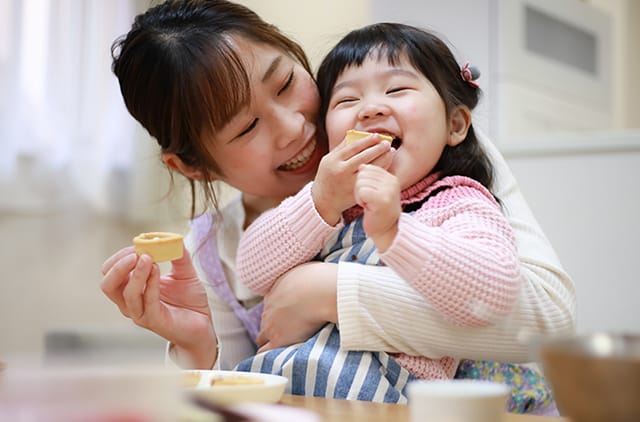 Mother and daughter eating the cake they made