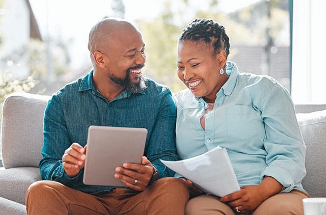a couple happily going over financial documents.