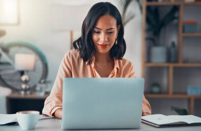 A woman working on a laptop.