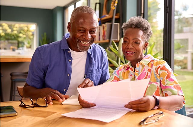 An older couple looking over financial documents.