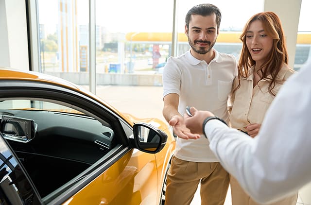 Couple buying new car at dealership