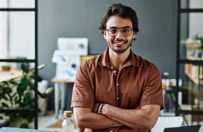 A young business owner smiling.