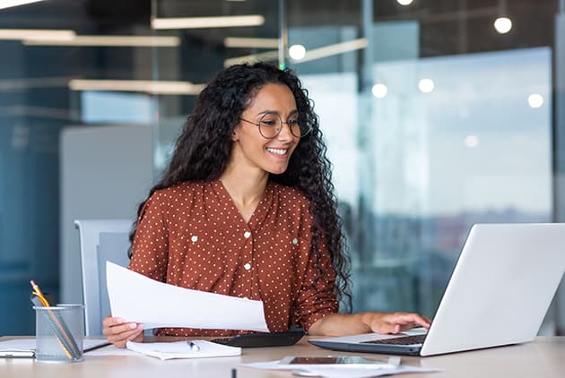 A woman looking over documents and planning.