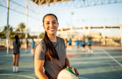 volleyball player holding a volleyball at outdoor sports court