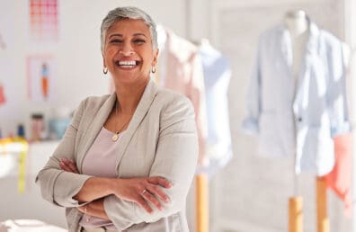 A small business owner smiling happily at the camera.