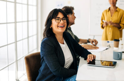 Successful business woman sitting in a boardroom with her colleagues