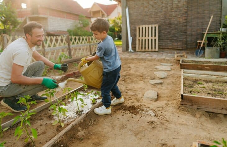 Photo of father and his boy in their organic garden