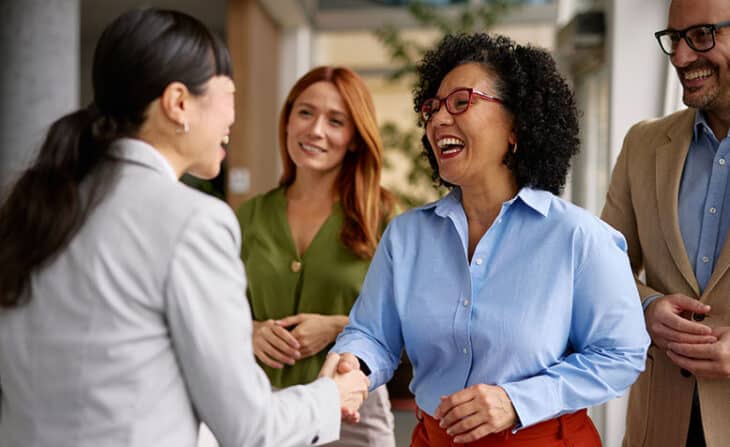 Diverse Business Colleagues Shaking Hands in a Modern Office