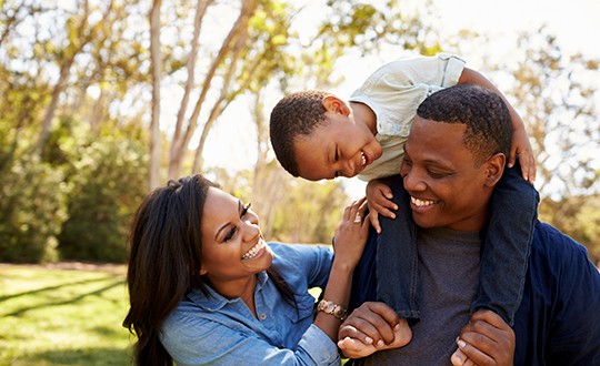 family of three enjoying the outdoors together