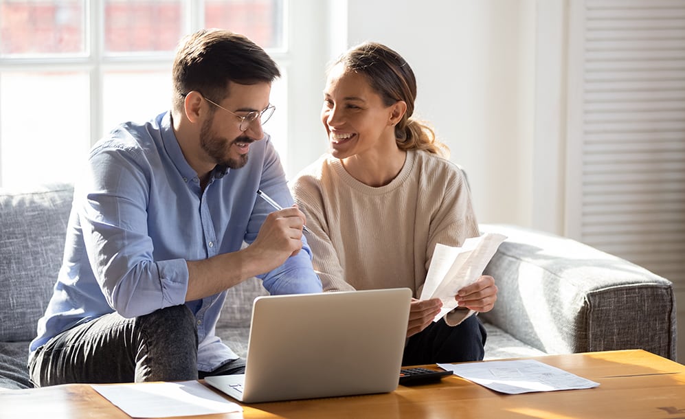 Couple working together on a laptop.
